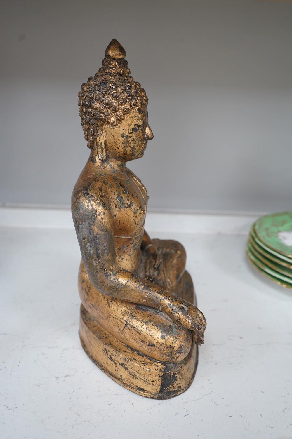 A Chinese gilt bronze figure of seated Buddha, 33cm high. Condition - fair, some holes